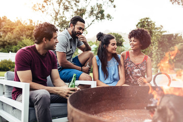 Young friends partying together in backyard