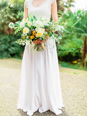 Fototapeta na wymiar Bride in white dress with wedding bouquet. Wedding style.