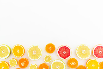 Food frame of fresh citrus fruits on white background. Flat lay, top view.