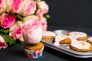 Cupcake with pink glaze on the wooden background. Selective focus.