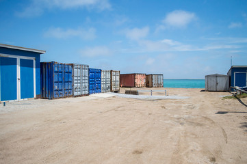 Naklejka premium Containers by a Turquoise Sea in Walvisbay, Namibia