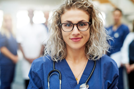 Blonde female medic in hospital looking at camera