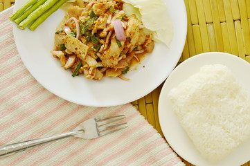 Thai spicy slice pork salad eat couple with sticky rice and fresh vegetable