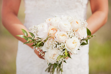 Bride holding a beautiful rose bouquet 