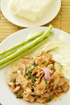 Thai spicy slice pork salad eat couple with sticky rice and fresh vegetable