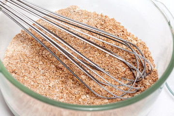 Wheat bran muffins preparation : Mixing dry ingredients to prepare integral wheat bran muffins