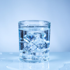 ice cube in glass of water