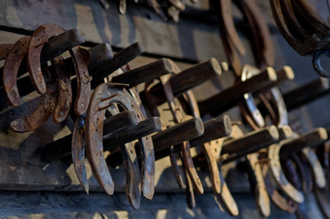 Brown rusty antique horseshoes in a barn