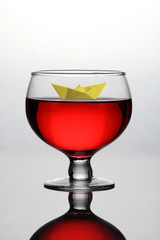 Red Wine Glass with a Paper Boat - Concept