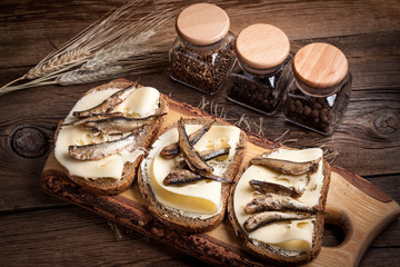 Sandwich with sprats and cheese.