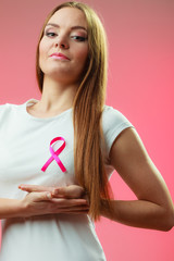 Woman wih pink cancer ribbon on chest