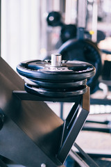 Obraz premium Set of metal barbells disks on barbbell holder in the fitness gym