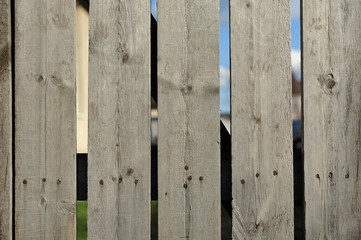 Fence from old boards, rough with nails