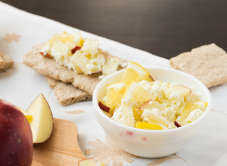 Healthy breakfast. Fresh healthy snack. Fruit salad with crispbread. Apples, lemon, sweet cottage cheese