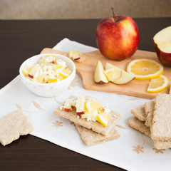 Healthy breakfast. Fresh healthy snack. Fruit salad with crispbread. Apples, lemon, sweet cottage cheese