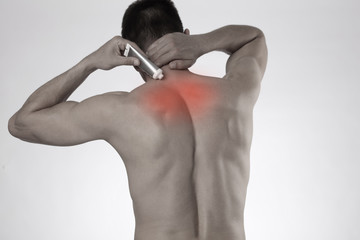 Man applying pain relieving cream, gel. Sport injury, Man with back, neck pain. Pain relief and...