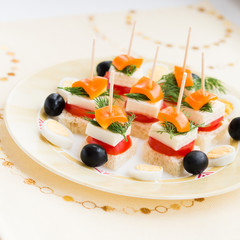 Cold snacks. Canapes of feta cheese and vegetables