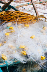 white fishing nets in the blue boat on the beach