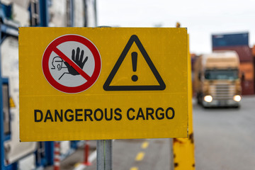 Signs warn of job security. Sign 'dangerous cargo'.