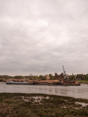 Low tide summer sky nightfall grey clouds mood and reds with river running through in wivenhoe essex uk england