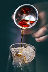 Pouring alcohol from a measuring glass