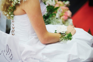 Young bride with flower decorations on her wrist