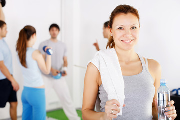 Beautiful cheerful woman taking a break after exercising.