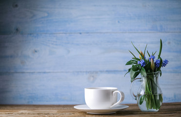 Coffee and a bowl with spring flowers