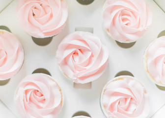 Cupcakes are packed in a box, soft pink cream cakes in the form of roses