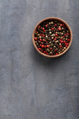 Pile of dry pepper in bowl on wooden table