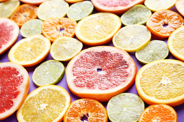 Fototapeta na wymiar Citrus fruits on a purple background