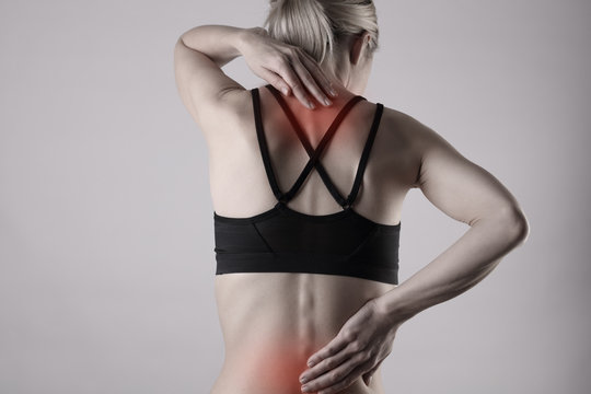 Woman suffering from back pain . Sports exercising injury.