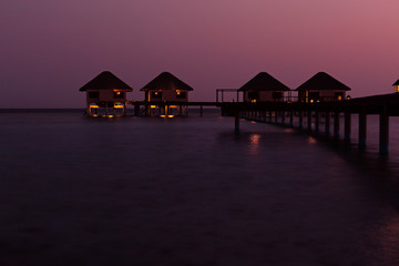  luxury water lodges at sunset on Maldive