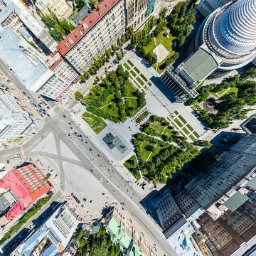 Aerial City View With Crossroads, Roads, Houses, Buildings, Parks And Parking Lots. Copter Drone Helicopter Shot. Panoramic Wide Angle Image.