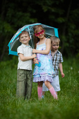Fototapeta premium happy children under umbrella in park