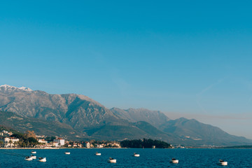 Lovcen in the snow. Snow on the mountain. View from Tivat. Waterfront Tivat in Montenegro.