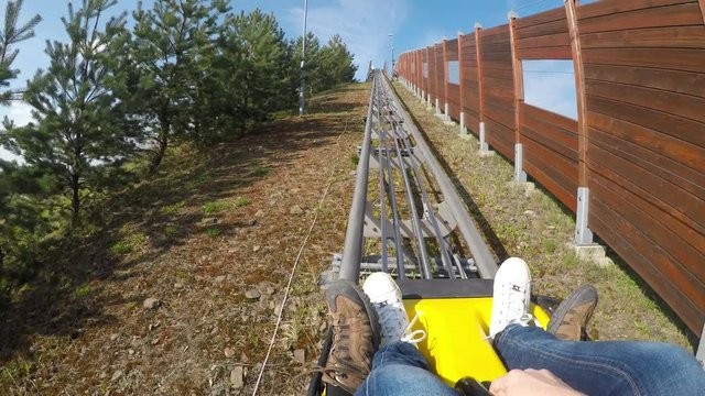 Fun on the bobsleigh track.
Young couple enjoying bobsled rides.