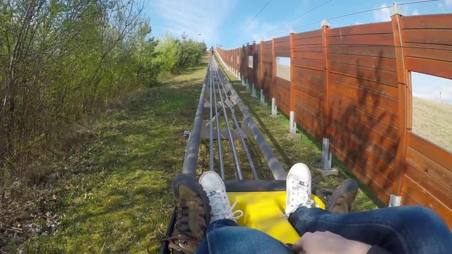 Fun on the bobsleigh track.
Young couple enjoying bobsled rides.