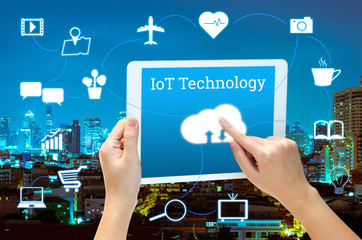 woman hand using smart phone in concept internet of things with blurred night modern city background