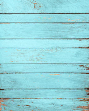 Vintage blue wood background with peeling paint.