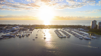 Aerial view over Marina Mirage and boats as the sunrises over the ocean, Gold Coast