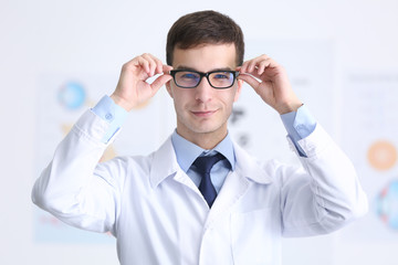 Handsome young ophthalmologist in clinic