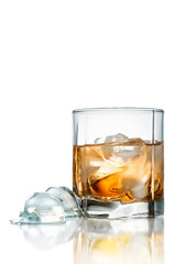 Glass of whiskey with ice isolated on white