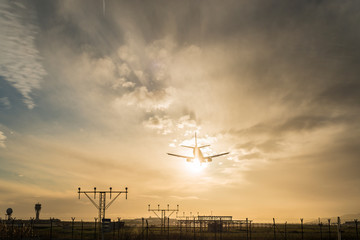 Airplane landing at dusk.