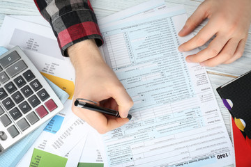 Man filling form of Individual Income Tax Return, closeup