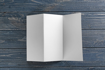 Blank brochure on wooden background