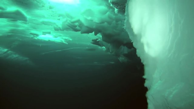 Ice underwater in the background of clear clear water in Arctic. Fantastic views of the lump of ice in water.