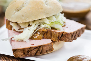 Portion of German Leberkaese on wooden background (selective focus)