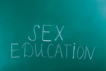 Text SEX EDUCATION written on chalkboard