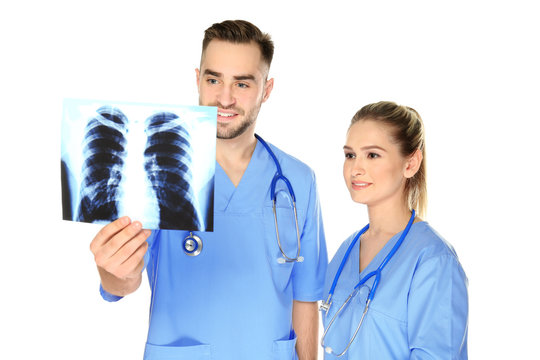 Doctor and medical assistant with x-ray image on white background